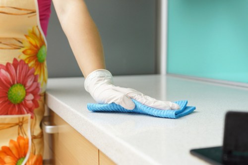Cleaner wearing PPE while handling carpet cleaning equipment