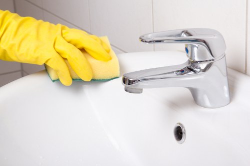 Professional cleaner managing cables and equipment to reduce slip and trip hazards